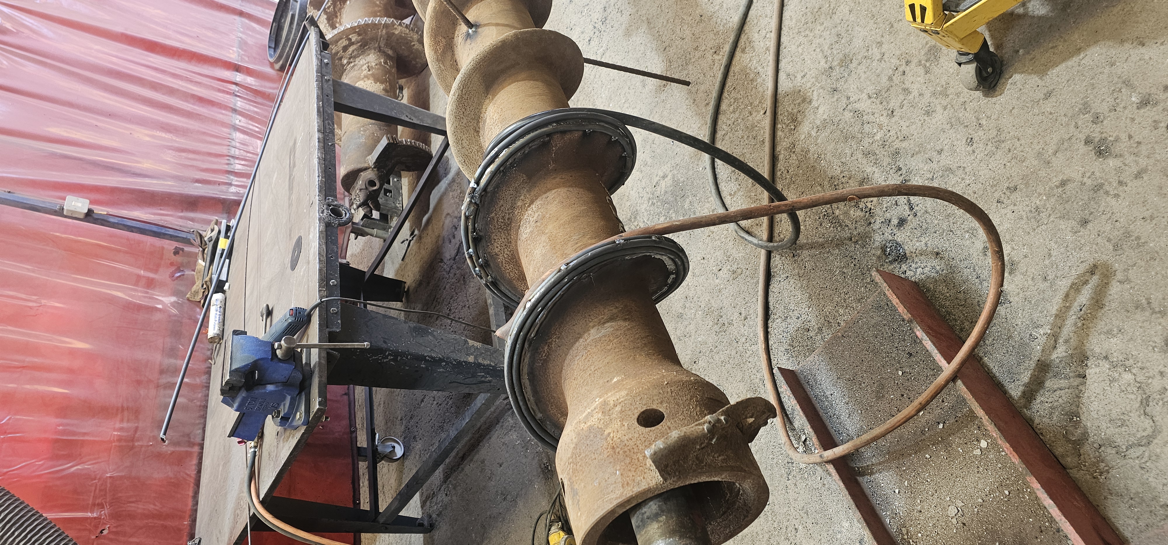 Auger hardfacing midway through build-up passes